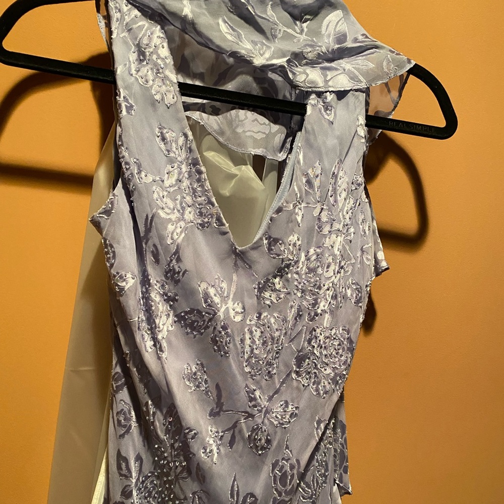 Long sleeveless fancy lavender dress with drape. Sealed in garment bag.